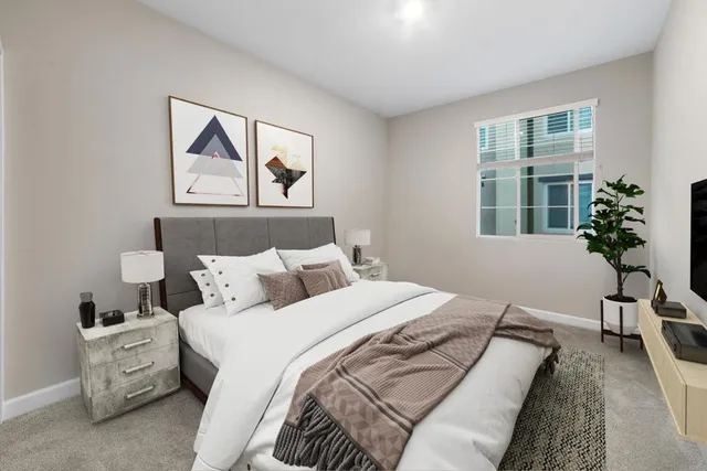 a bedroom with a bed and a painting on the wall