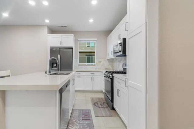 a large kitchen with a table and chairs