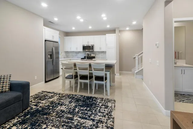 a kitchen with stainless steel appliances granite countertop a stove and a refrigerator