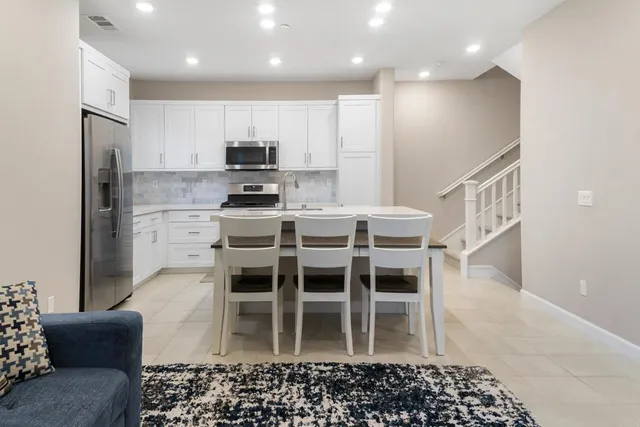 a kitchen with a sink a microwave and cabinets