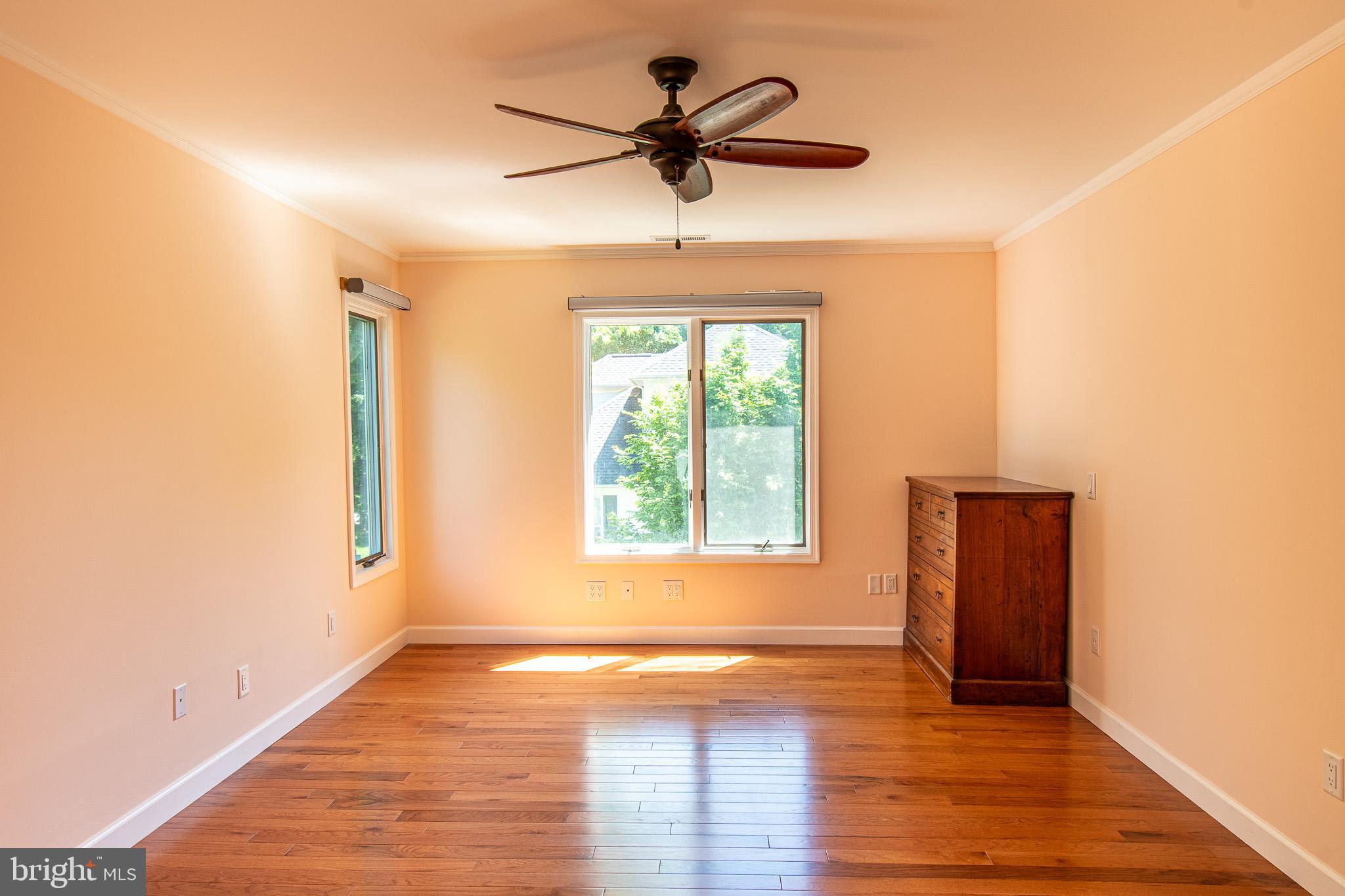 102 Jacks Point Road Oxford, MD 21654 - Photo 47 of 83 a view of empty room with wooden floor and fan