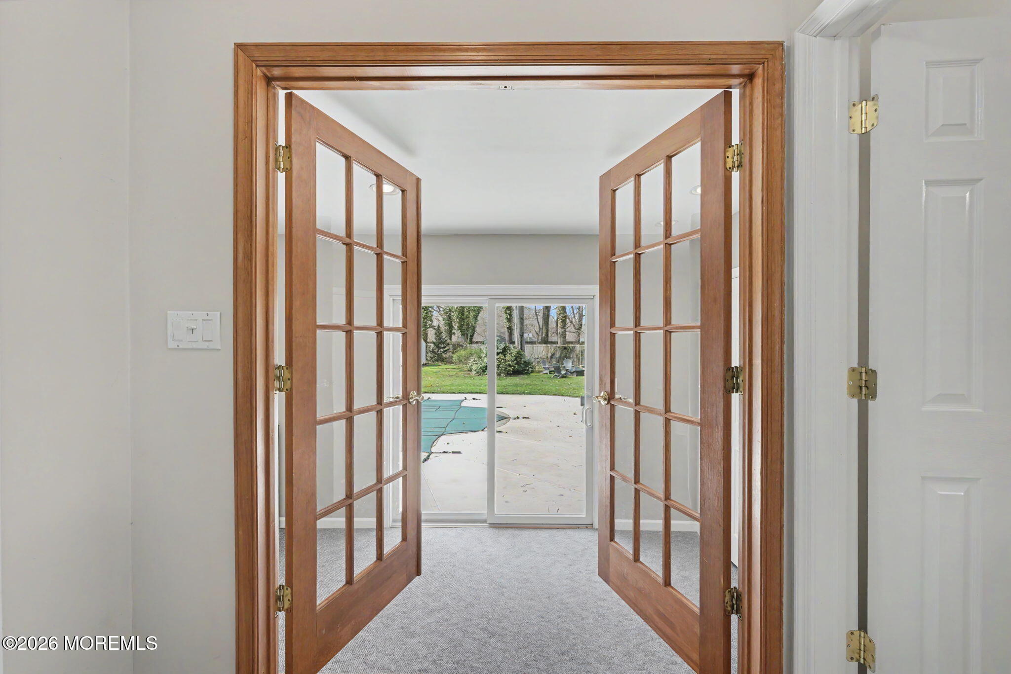 49 Hampton Drive Freehold, NJ 07728 - Photo 13 of 34 a view of a hallway with large windows and kitchen view