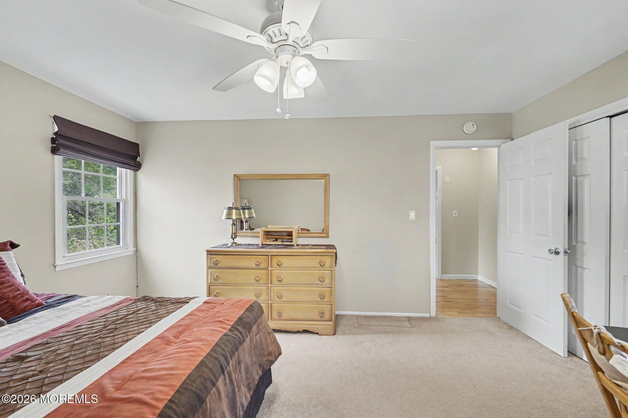 49 Hampton Drive Freehold, NJ 07728 - Photo 24 of 34 a bedroom with a bed and a chandelier