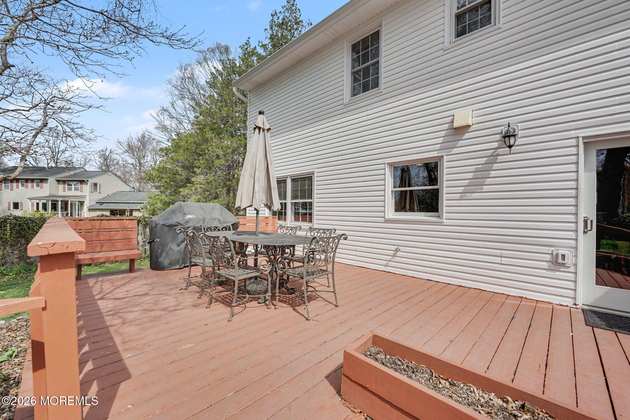 49 Hampton Drive Freehold, NJ 07728 - Photo 27 of 34 a view of a patio with table and chairs and wooden floor