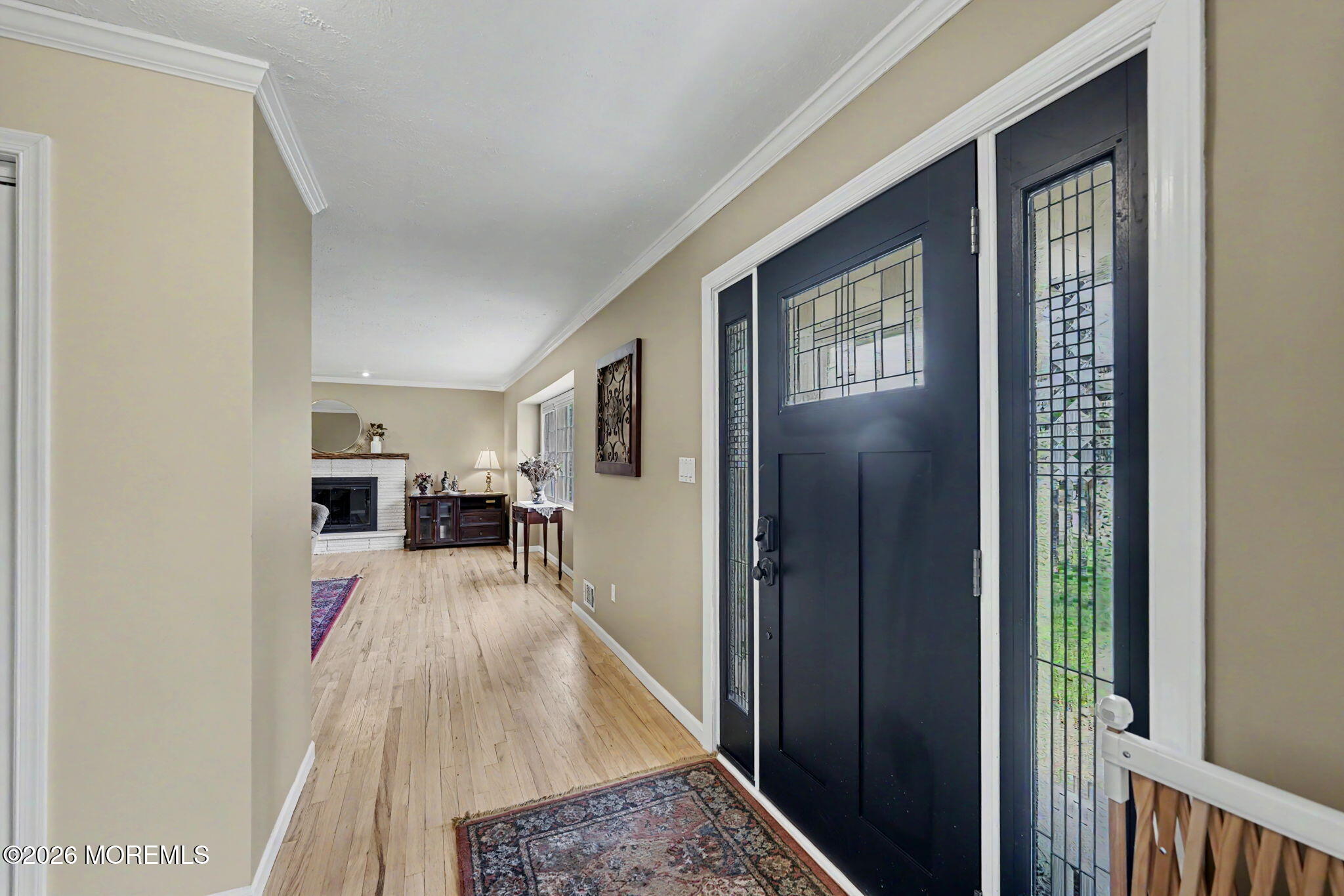 49 Hampton Drive Freehold, NJ 07728 - Photo 4 of 34 a view of a hallway to a livingroom and a dining room with furniture