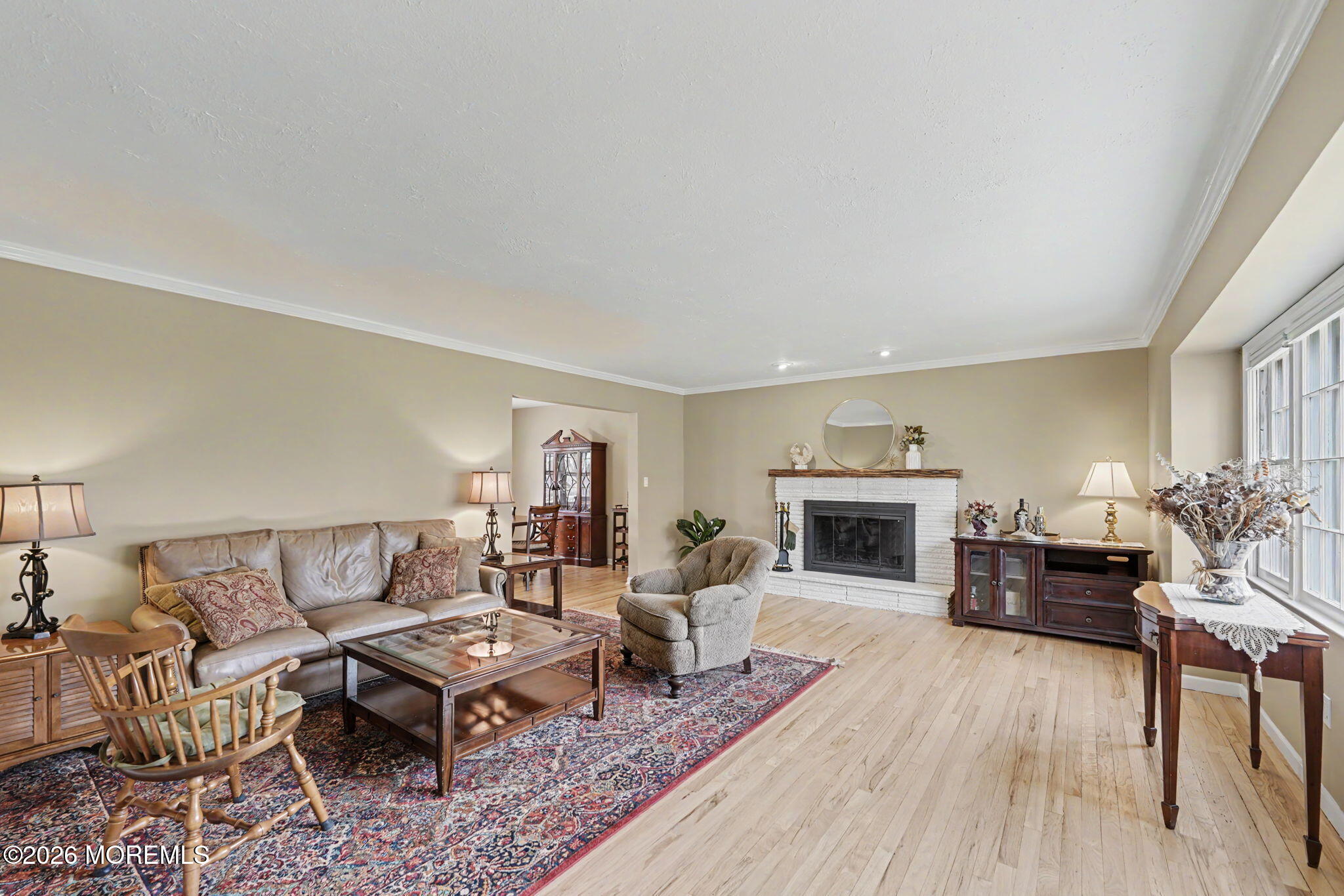 49 Hampton Drive Freehold, NJ 07728 - Photo 6 of 34 a living room with furniture a fireplace and a table