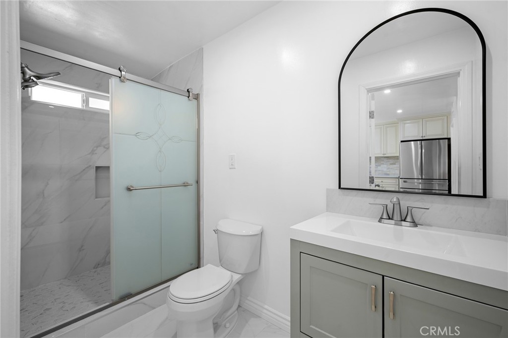 685 Rim Road Pasadena, CA 91107 - Photo 14 of 27 a bathroom with a sink toilet and shower