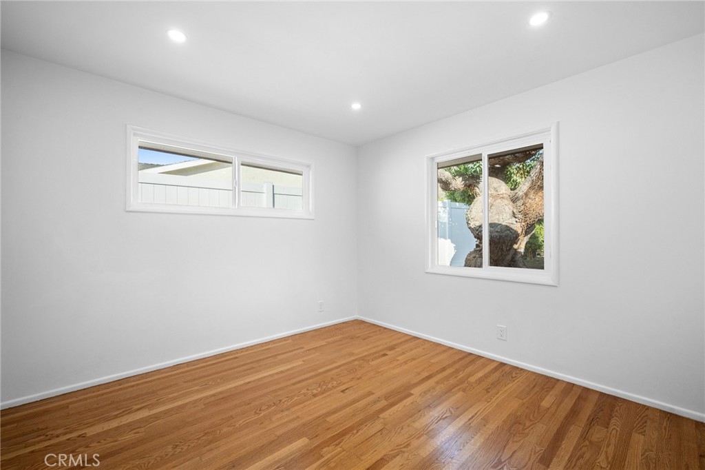 685 Rim Road Pasadena, CA 91107 - Photo 19 of 27 a view of empty room with wooden floor and fan