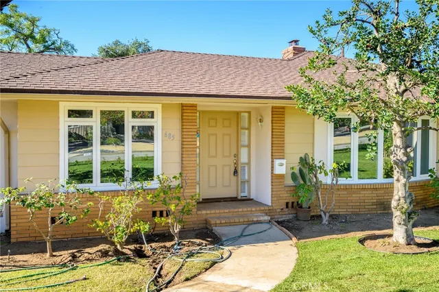 a view of house with backyard outdoor seating and plants
