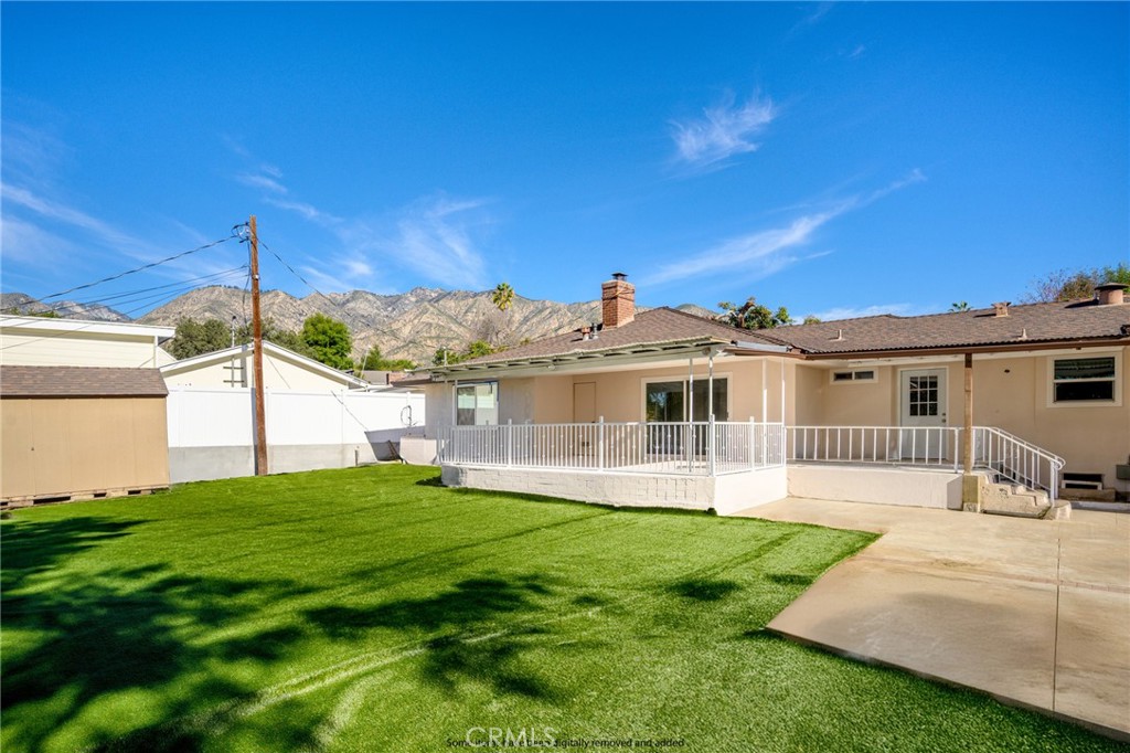 685 Rim Road Pasadena, CA 91107 - Photo 22 of 27 a front view of a house with a yard and porch