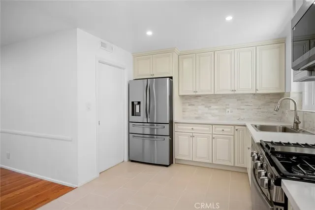 a kitchen with stainless steel appliances a refrigerator stove and sink