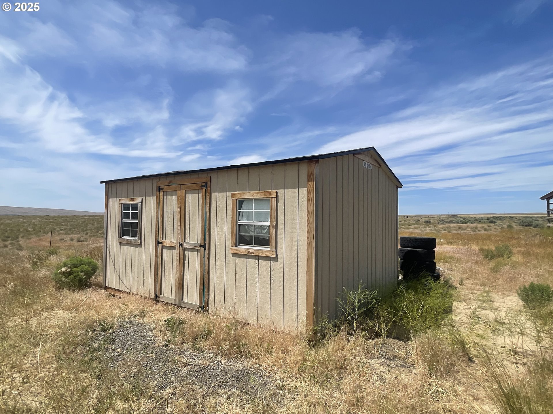 38 Vineyard View Drive Prosser, WA 99350 - Photo 12 of 20 a backyard of a house with lots of green space and lake view