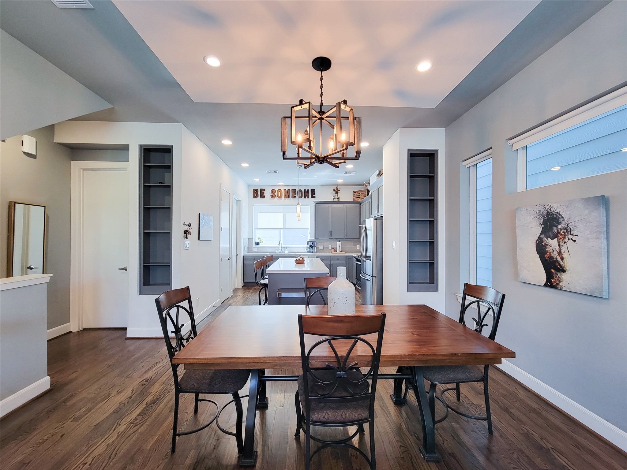 1705 Eado Point Lane Houston, TX 77003 - Photo 21 of 50 A modern dining area with windows for natural light and built-in shelves. Modern light fixtures and a half bathroom for easy access to facilities.