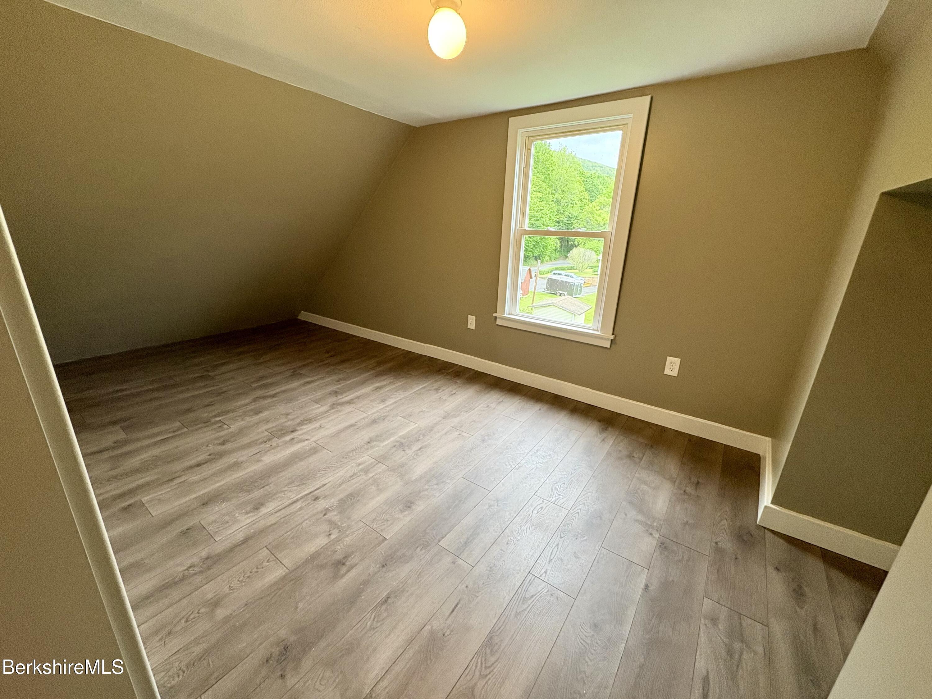 319 Old Columbia Street Adams, MA 01220 - Photo 12 of 15 a view of an empty room with wooden floor and windows