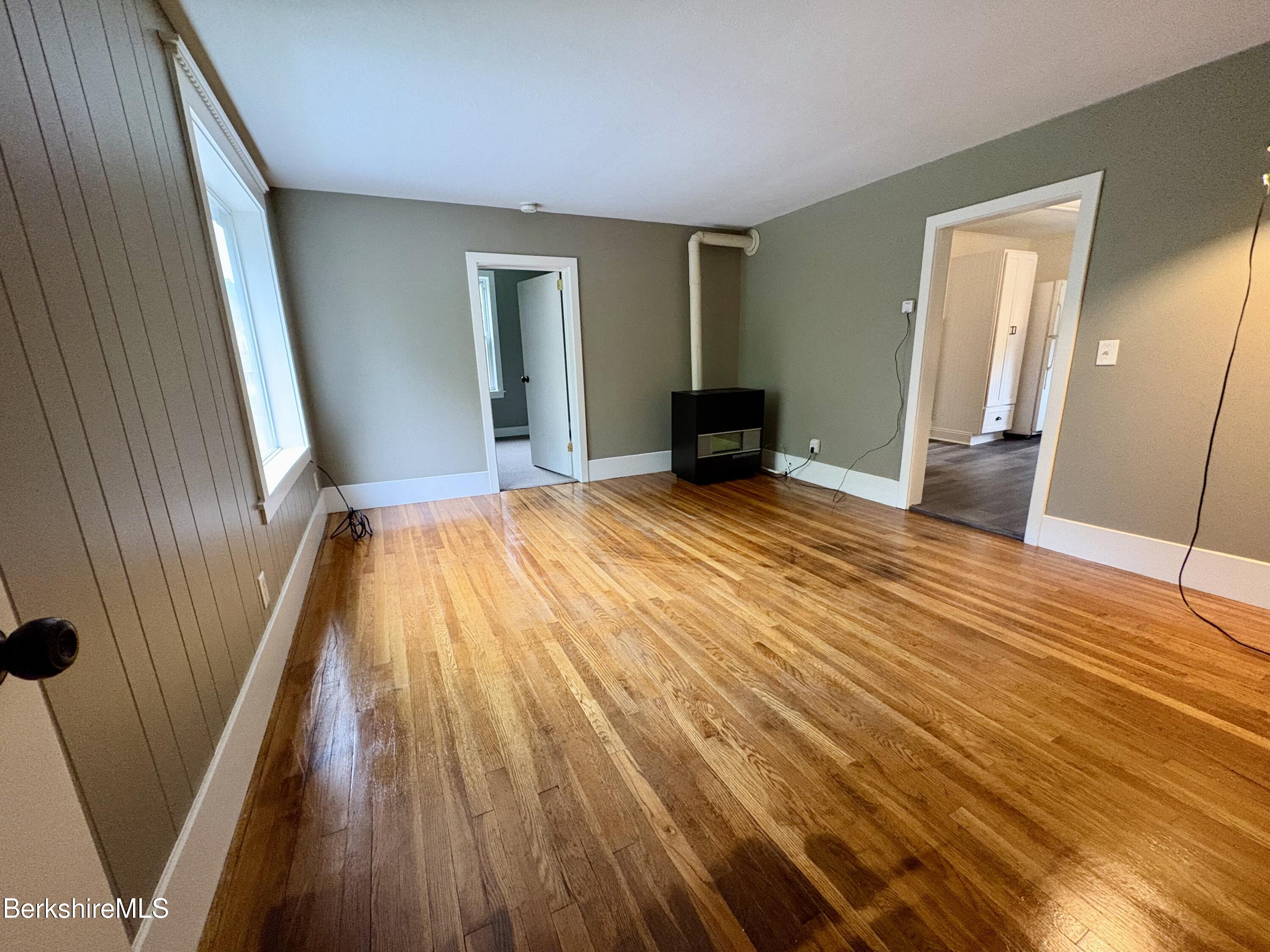 319 Old Columbia Street Adams, MA 01220 - Photo 6 of 15 a view of an empty room with wooden floor and a window