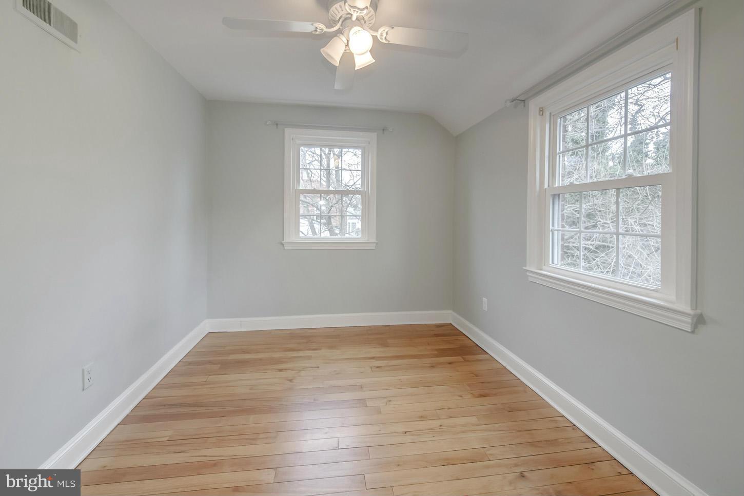 9521 Thornhill Road Silver Spring, MD 20901 - Photo 22 of 30 a view of an empty room with wooden floor and a window