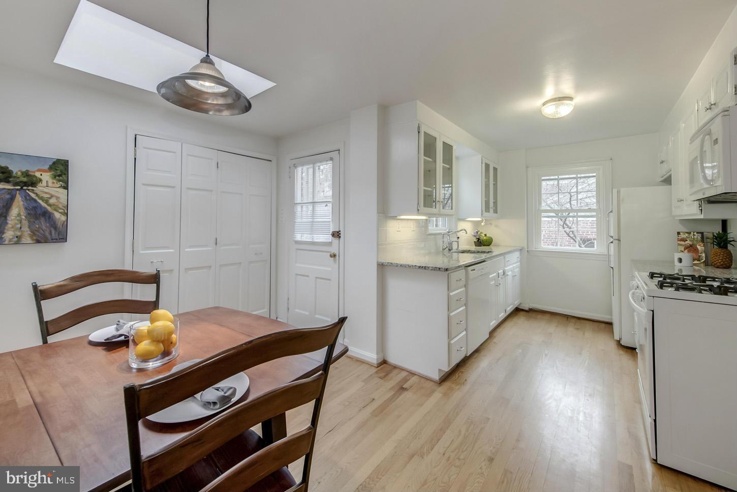 9521 Thornhill Road Silver Spring, MD 20901 - Photo 8 of 30 a kitchen with a table chairs and wooden floor