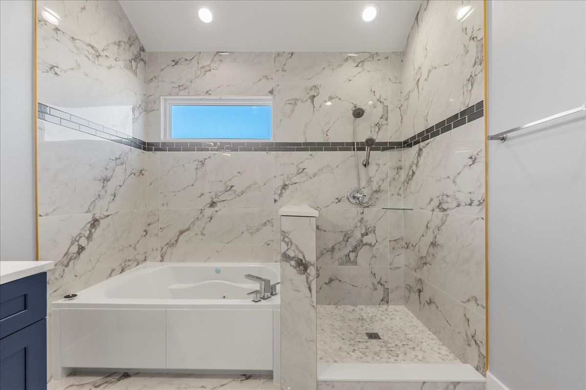217 Gato Road Cedar Creek, TX 78612 - Photo 26 of 40 a bathroom with a bathtub and shower