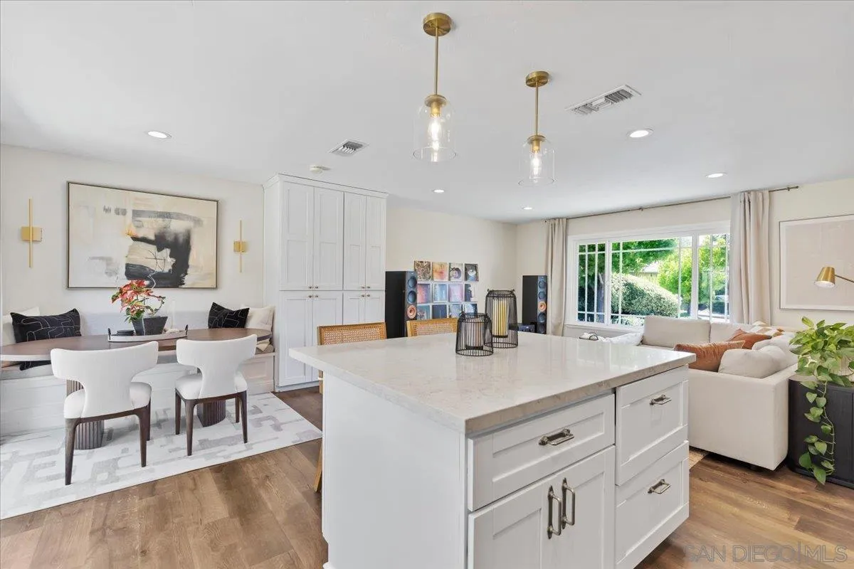 12243 Buckskin Trail Poway, CA 92064 - Photo 12 of 41 a view of kitchen island a sink and living room view