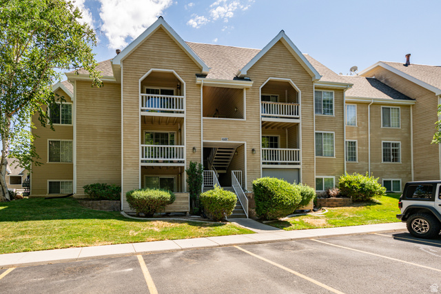 1221 Waterside Cove, Unit 11 Midvale, UT 84047 - Photo 1 of 23 Multi-level condominium building featuring tan siding and multiple balconies with white railings