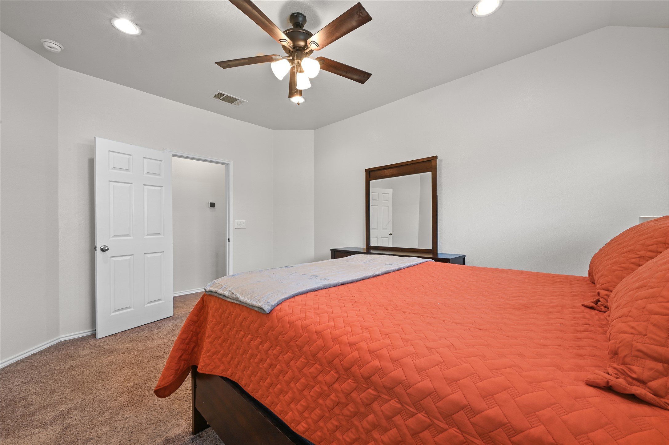 303 Limerick Road Buda, TX 78610 - Photo 12 of 23 Bedroom featuring vaulted ceilings with recessed lighting, a ceiling fan with light fixture, carpeted flooring, and a six-panel interior door
