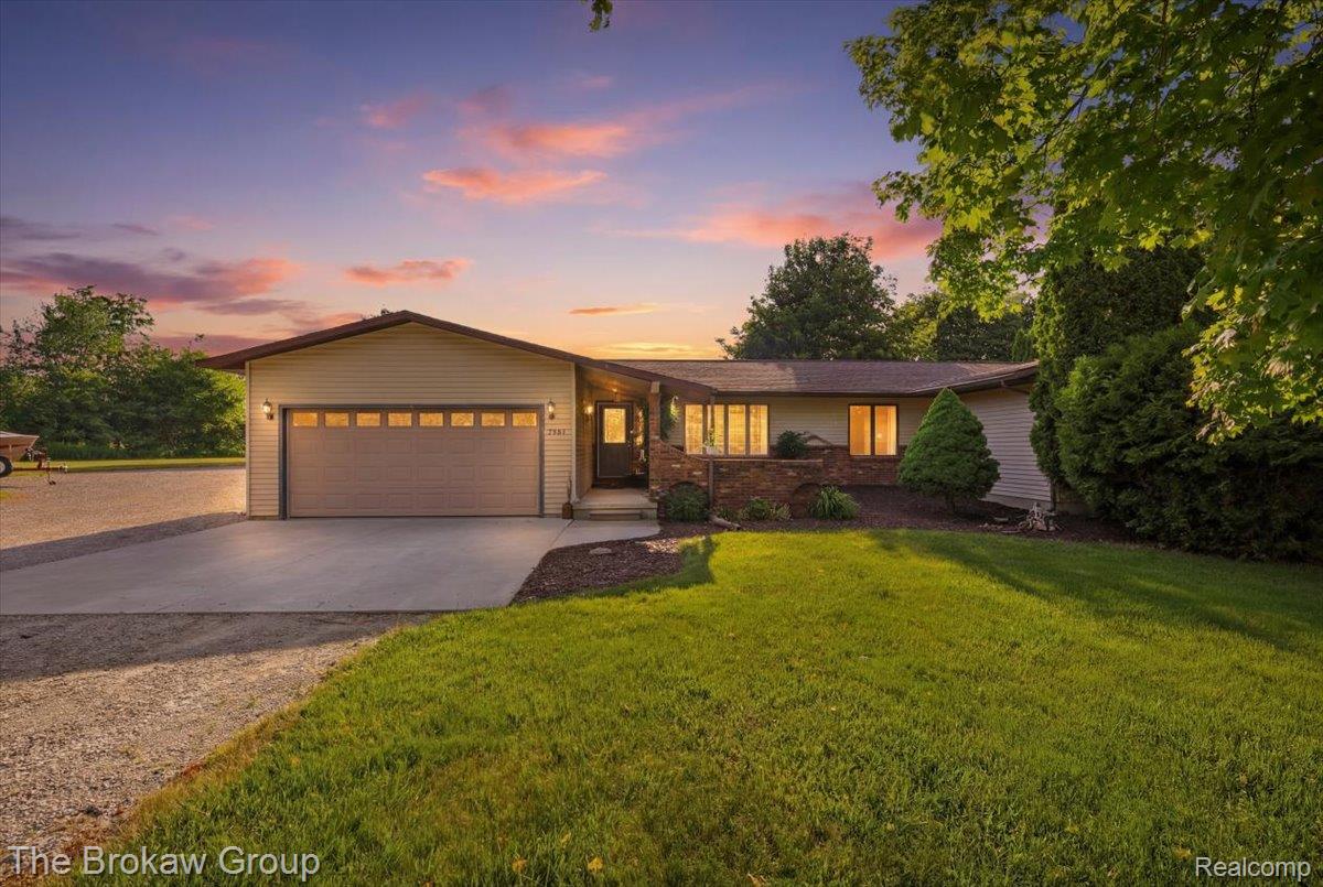 Ranch-style residence featuring a two-car attached garage, concrete driveway, and brick accent facade