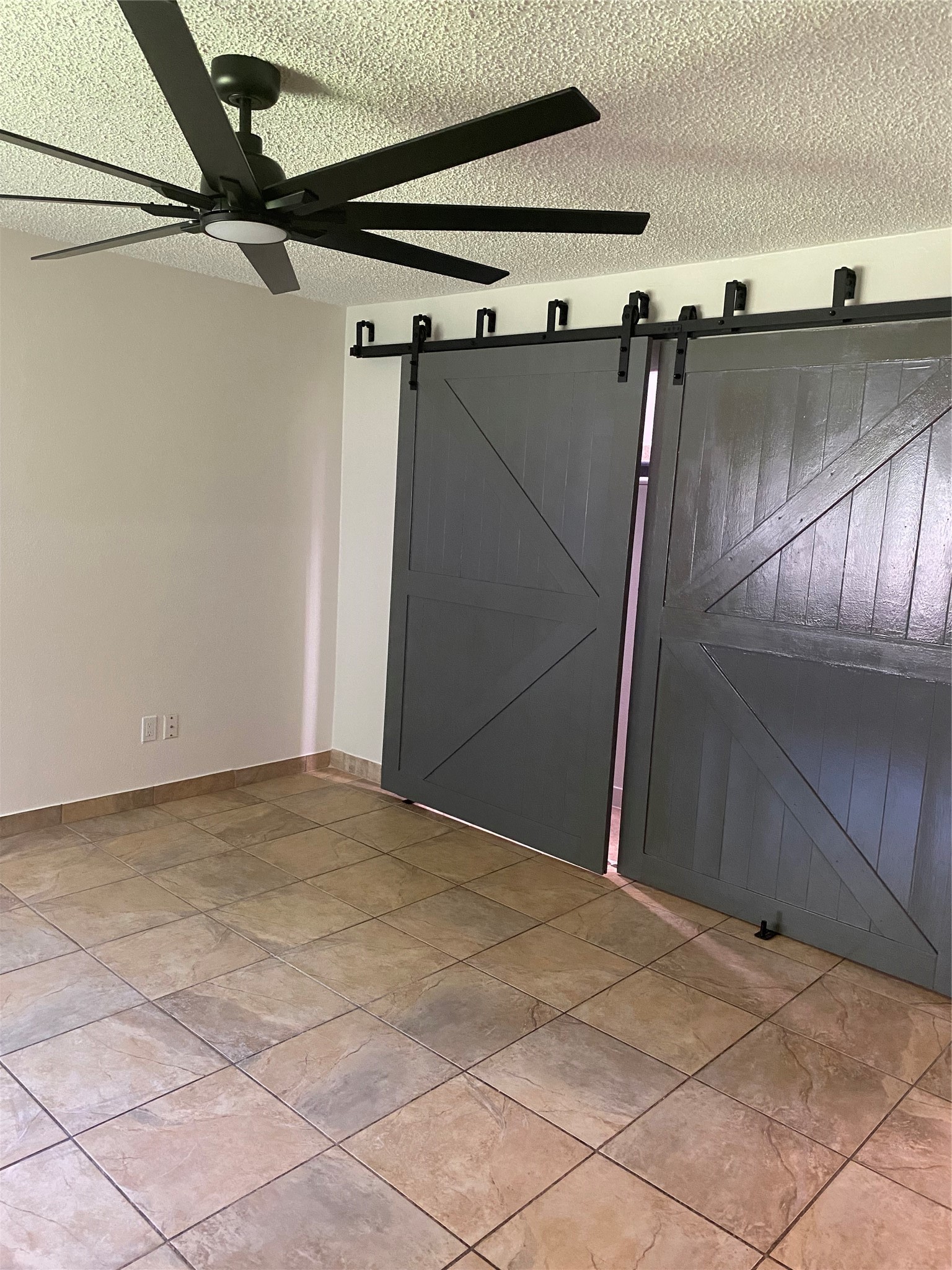 3107 Raccoon Run Spring, TX 77373 - Photo 20 of 35 Master bedroom with 72" ceiling fan and barn door