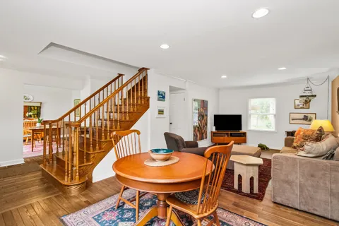 a living room with dining room and wooden floor