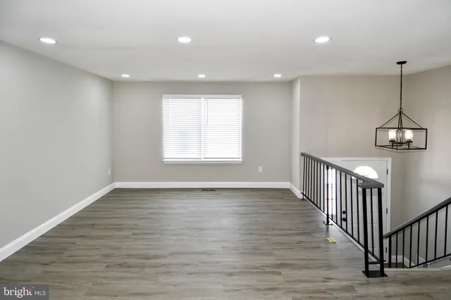 a view of a room with wooden floor windows and stairs