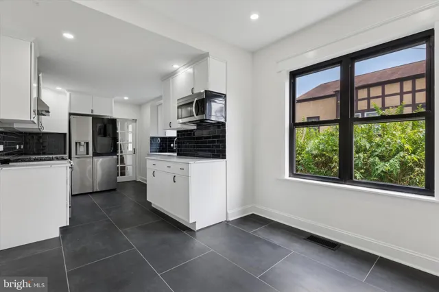 an empty room with a window and a ceiling fan