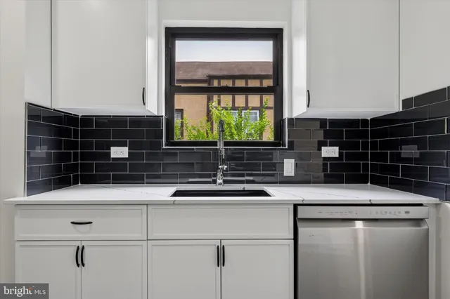 a bathroom with double vanity sink and a mirror