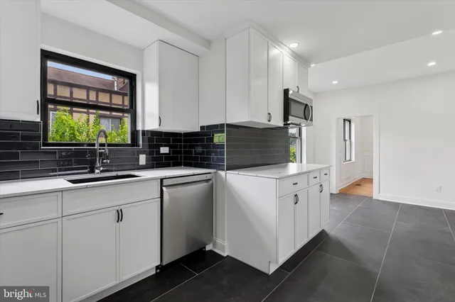 a view of a hallway with wooden floor and stairs