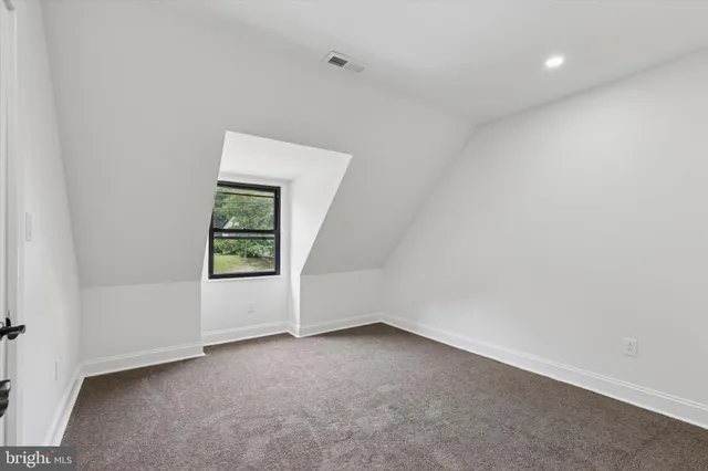 a view of hallway with stairs and wooden floor