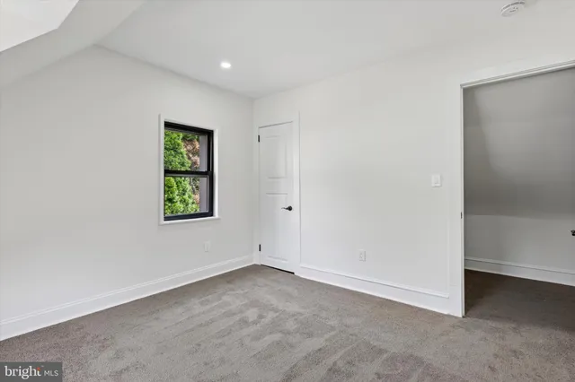 a view of an empty room with windows