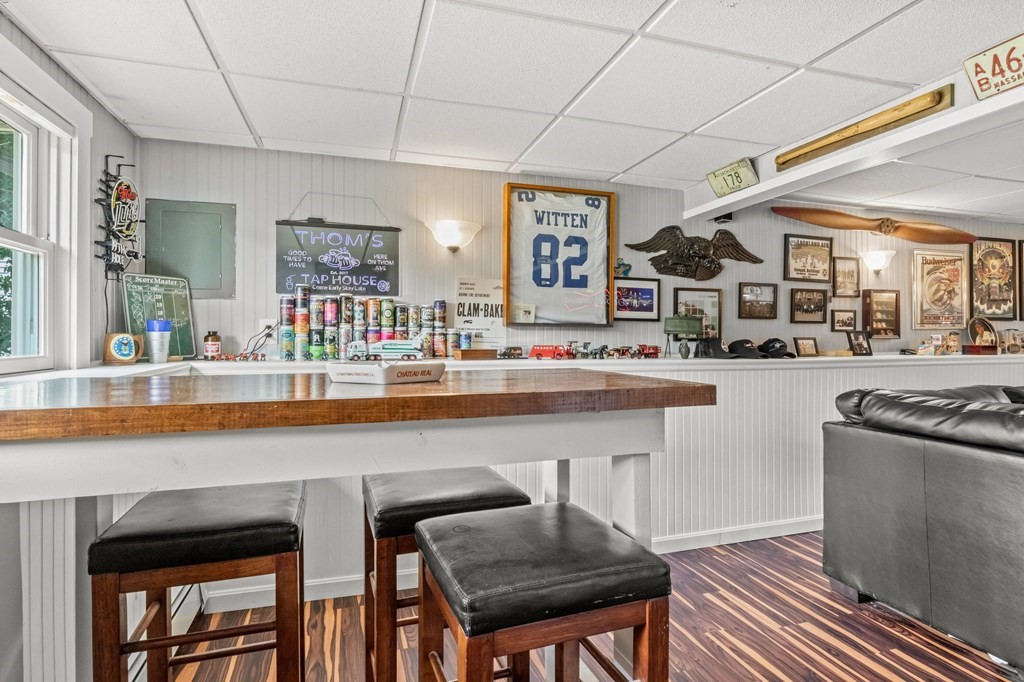 61 Thom Avenue Bourne, MA 02532 - Photo 18 of 32 a kitchen with stainless steel appliances granite countertop a table chairs in it and wooden floors