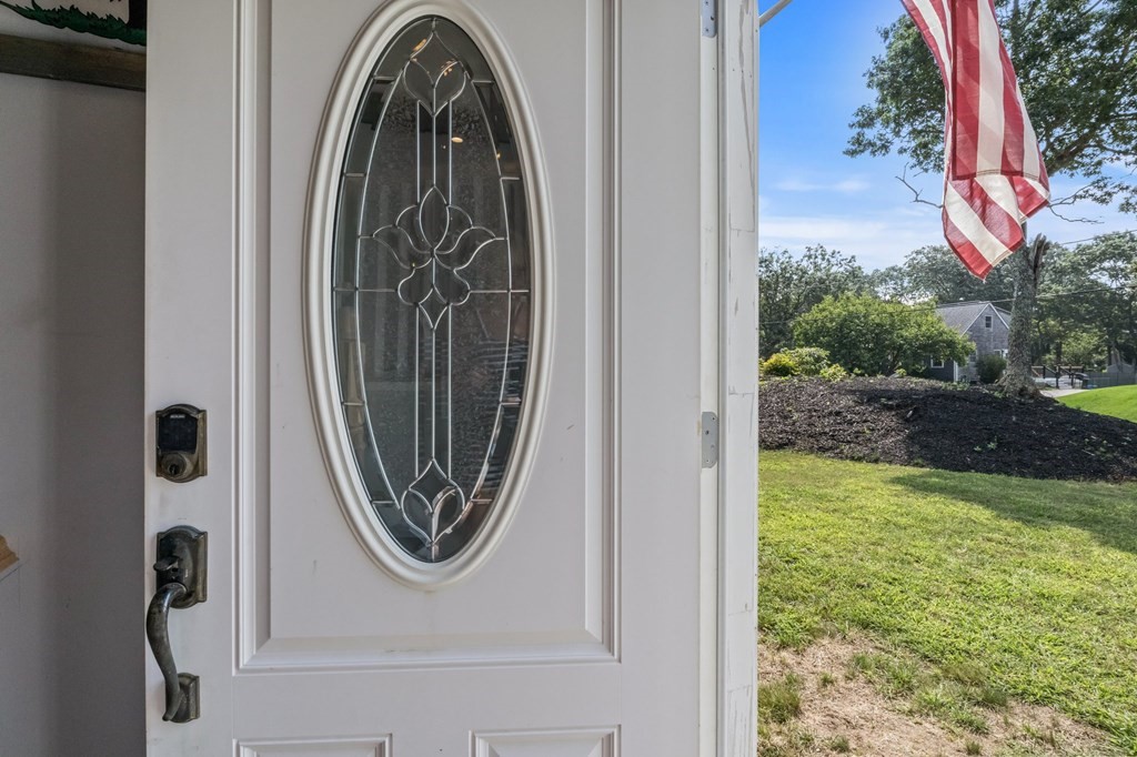 61 Thom Avenue Bourne, MA 02532 - Photo 2 of 32 a view of a door of a house with a small yard and wooden floor
