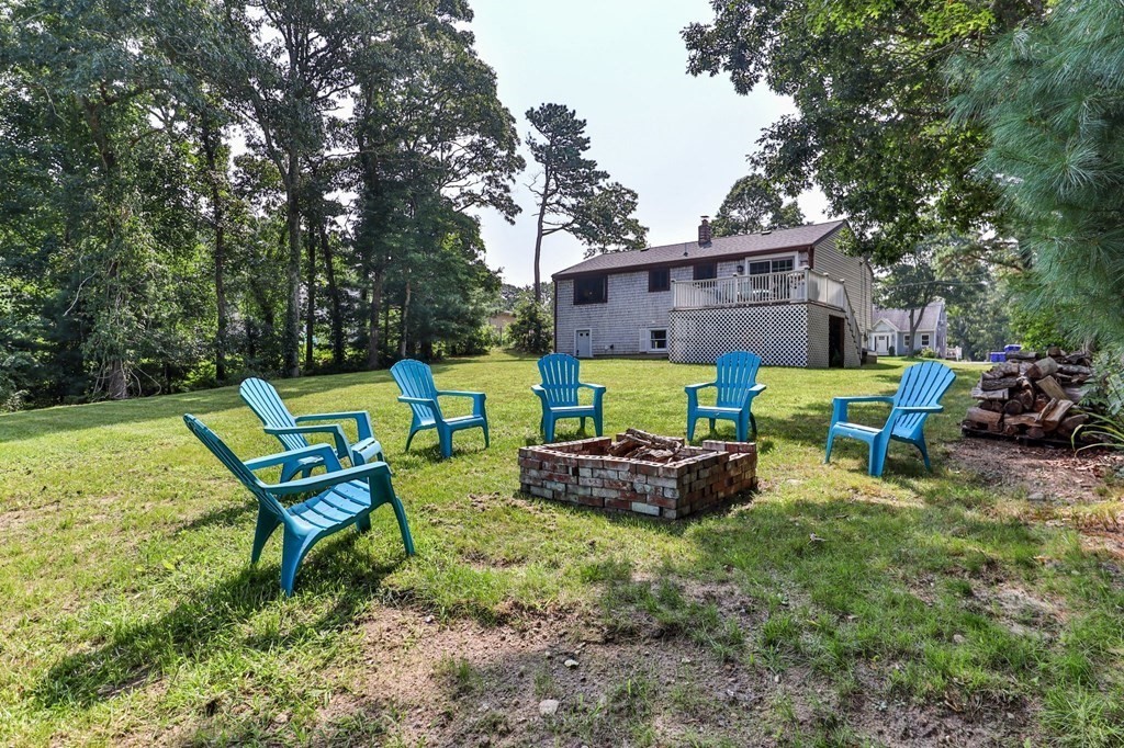61 Thom Avenue Bourne, MA 02532 - Photo 29 of 32 a view of backyard with outdoor seating ad green space