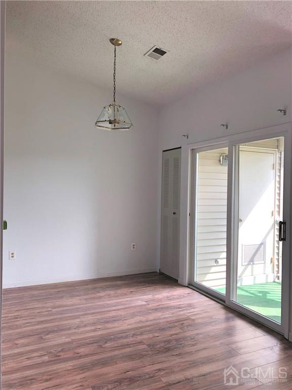 1237 Edpas Road, Unit 1237 New Brunswick, NJ 08901 - Photo 11 of 29 a view of a room with wooden floor and a ceiling fan