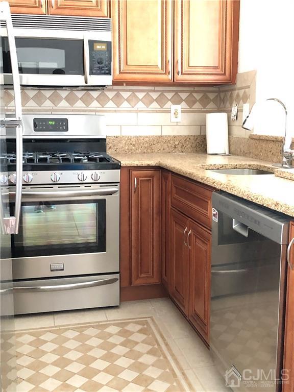 1237 Edpas Road, Unit 1237 New Brunswick, NJ 08901 - Photo 14 of 29 a stove top oven sitting inside of a kitchen