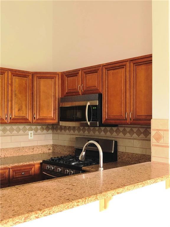 1237 Edpas Road, Unit 1237 New Brunswick, NJ 08901 - Photo 15 of 29 a kitchen with a sink a stove and cabinets