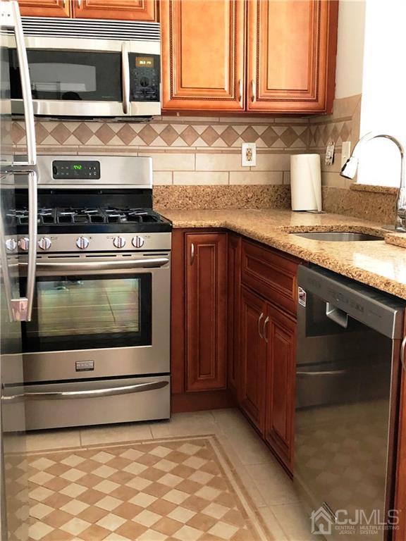 1237 Edpas Road, Unit 1237 New Brunswick, NJ 08901 - Photo 16 of 29 a kitchen with granite countertop a stove and a sink