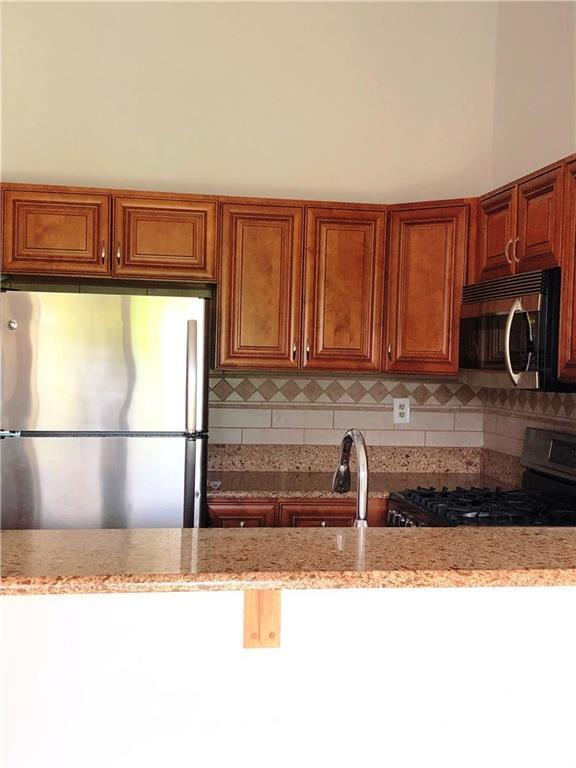 1237 Edpas Road, Unit 1237 New Brunswick, NJ 08901 - Photo 17 of 29 a kitchen with a sink and a refrigerator