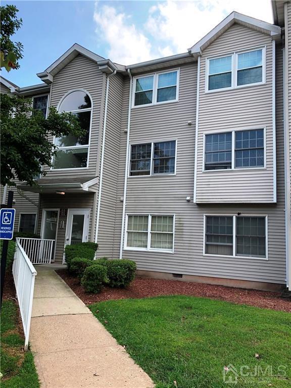 1237 Edpas Road, Unit 1237 New Brunswick, NJ 08901 - Photo 2 of 29 a front view of a house with a yard and garage
