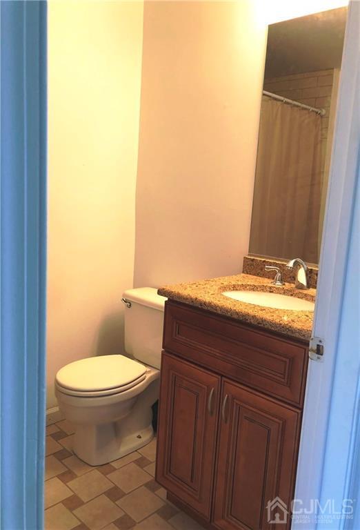 1237 Edpas Road, Unit 1237 New Brunswick, NJ 08901 - Photo 6 of 29 a bathroom with a granite countertop toilet and a sink