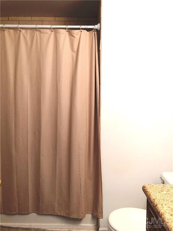1237 Edpas Road, Unit 1237 New Brunswick, NJ 08901 - Photo 7 of 29 a bathroom with a granite countertop sink and toilet