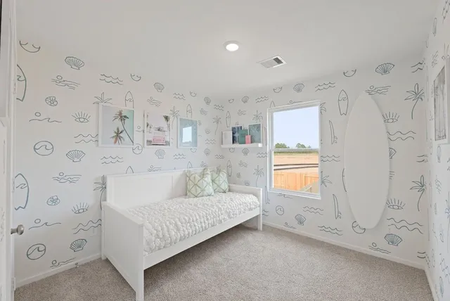 a living room with furniture and a dresser