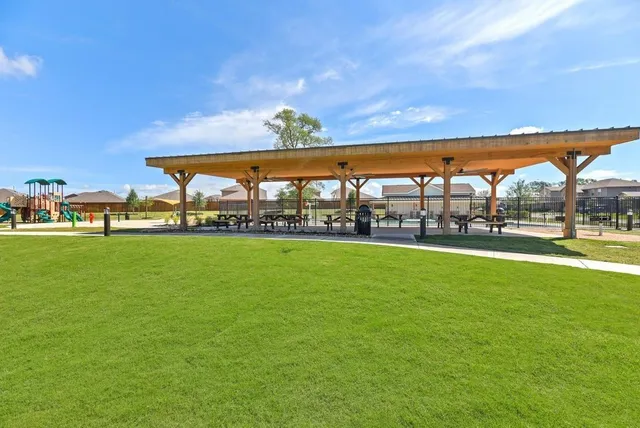 a view of outdoor space with green field and trees