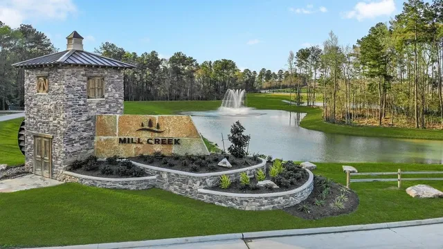a view of a garden with swimming pool and outdoor seating