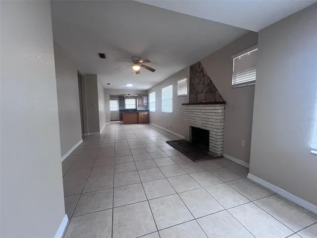 a view of a livingroom with an empty space and a fireplace