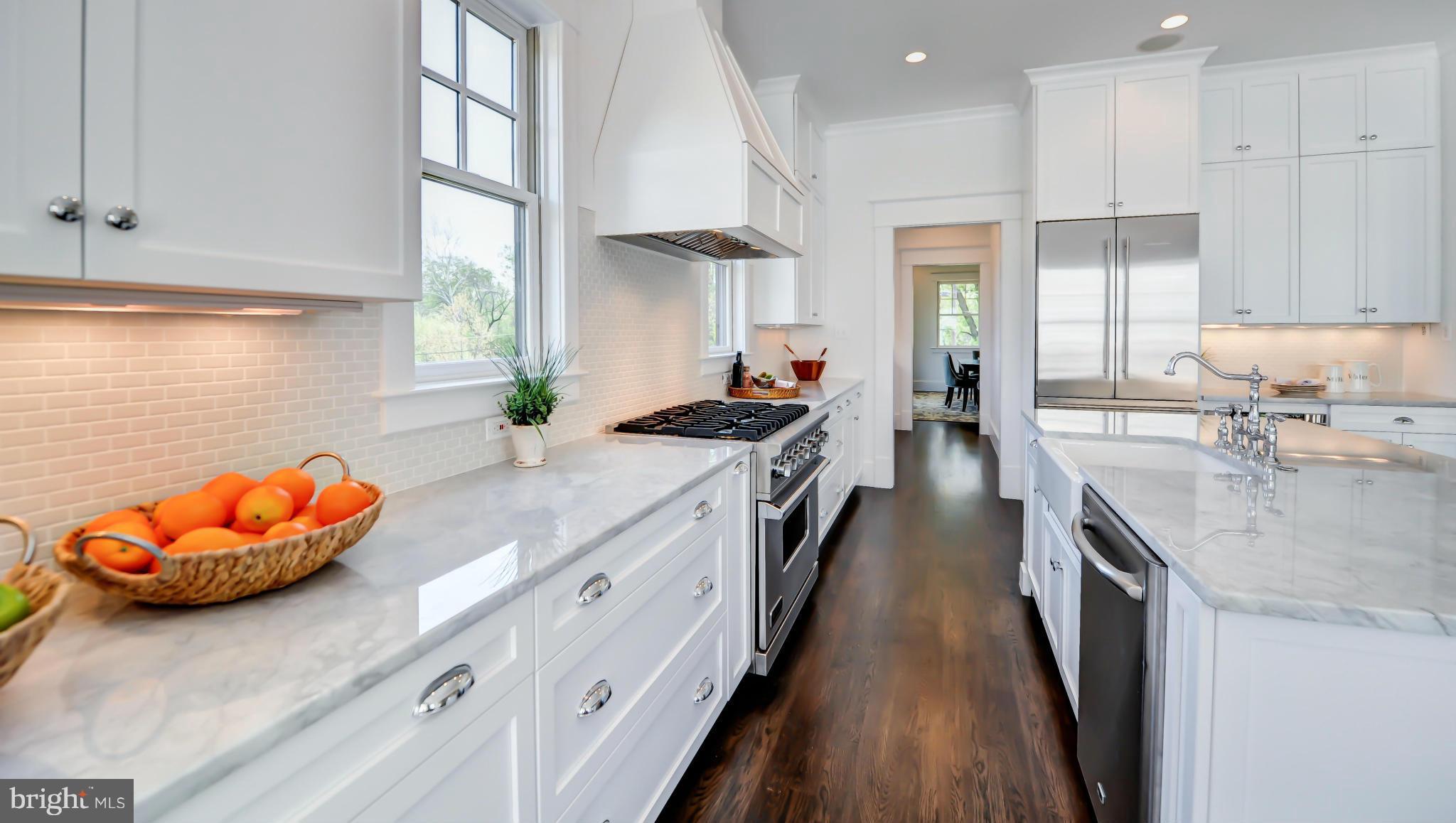 2735 Lorcom Lane Arlington, VA 22207 - Photo 11 of 30 a kitchen with stainless steel appliances granite countertop a stove a sink and a refrigerator